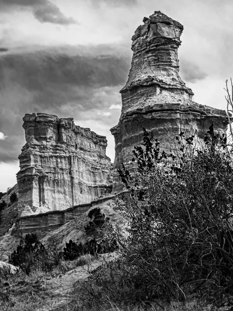 Clouds and weathered stone give Lighthouse Rock a different character in this black-and-white view.